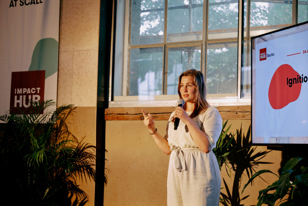 A woman presenting on stage