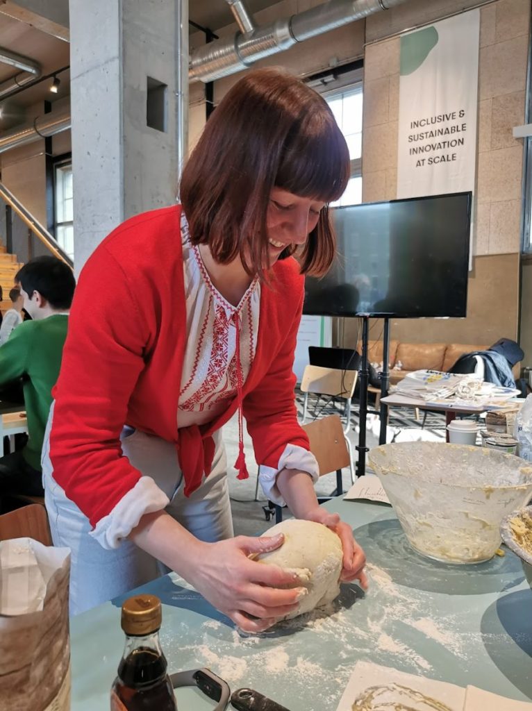 A woman kneading dough